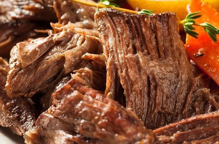 Receta de tapapecho en olla a presión: Cocción profunda y deliciosa 1 Tapapecho de res guisado en su salsa en una olla a presión, listo para ser servido.