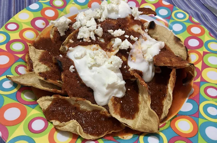 Chilaquiles Chilaquiles rojos con crema, queso fresco y huevo frito, receta mexicana casera